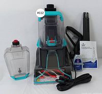 Full lot with floor finishing machine, cleaning tank, power cord, black attachments, cleaning solution, and instruction manual on white background.