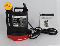 Photo of DEKO CSP9025 water pump showing front label and attached power cord, with original instruction manual placed behind pump.