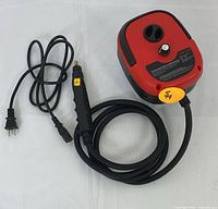 Portable steam cleaner with power cord and flexible hose attached, compact red and black body with control features.