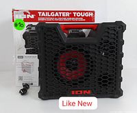 Front view of the ION Tailgater Tough speaker showing its rugged black and red design with hexagonal grill and original box in the background, includes user manual and charging cable.