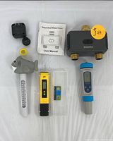 Full lot displayed including Insoma dual water timer, user manual, yellow digital pH meter with case, blue TDS meter, floating thermometer with shark design, fittings, and adapter.
