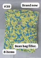 Photo showing one sealed bag of yellow and blue shredded memory foam labeled as bean bag filler, brand new, lot of 8 items