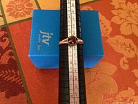 Ring on ring mandrel showing size and gemstone