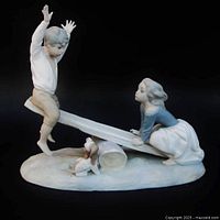 Front view of the Lladro porcelain seesaw figurine showing boy and girl with puppy below