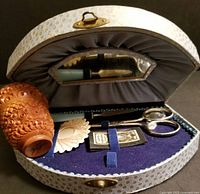 Image showing opened vintage sewing box with fitted sewing tools inside and carved needle holder on the left side