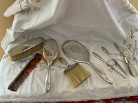 Entire eight-piece set on embroidered cloth