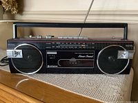 Front view showing entire boombox with speakers, cassette player and radio scale visible