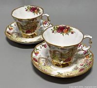 Two vintage Royal Albert Old Country Roses teacups with matching saucers shown side by side, displaying floral and pastoral pattern and gold trim.