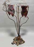 Full front view of the copper and brass metal art sculpture candleholder showing the base and stems, two tulip-shaped candle cups with wired detailing