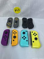 All four pairs of Nintendo Switch Joy-Con controllers arranged in two rows by color and type, showing left and right sides of each pair.