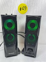 Two black SENGOO RGB gaming speakers showing green lighting on the speaker grills, front view.