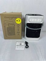 Photo of cooling fan with box, USB Type-C cable and user manual on white surface, showing full contents of lot.