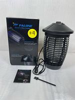 Photo showing Palone electric bug zapper with box, instruction manual and cleaning brush on white background