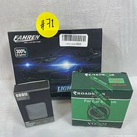 Boxed Fahren LED Headlight Kit showing 300% brighter label, boxed OBDII scanner, boxed Roadstar VO-402 car speaker.