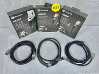 Three black Ultralink Ultra High Speed HDMI cables with Ethernet in front of their original packaging showing branding and product details. Each box highlights 8K and 4K support.
