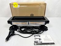 Front view of Xprite LED strobe rooftop flashing light bar with power cable and instruction sheet in front of brown cardboard box.