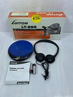 Photo showing boxed Luiton LT-298 CB radio and Craig personal CD player in blue, headphones, batteries, and manuals.
