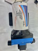 Side view of EVTSCAN diaphragm water pump showing model number F42-103-068-101 and technical details on the motor housing.