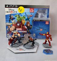 Front view of the Disney Infinity 2.0 Marvel Super Heroes Starter Pack for PS3 including box, game case, base platform, Thor, Black Widow, Iron Man figures and power disk.