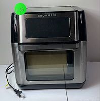 Front exterior view of the Crownful Smart Air Fryer showing the digital control panel area and glass door closed.