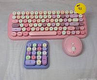 Front view showing the Mofii Candy keyboard with pink base and pastel round keys, pink wireless mouse, and separate pastel-colored numeric keypad.