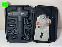 Wattne W2 massager and accessories organized inside black carrying case: six attachments, charger, user manual.