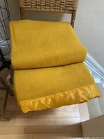 folded mustard wool blanket on chair showing overall appearance