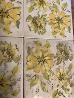 Close-up of four tiles showing yellow flowers and green leaves
