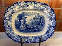 Full view of blue-white oval platter on stand