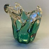 Front view of green Murano vessel showing scalloped rim and color transition