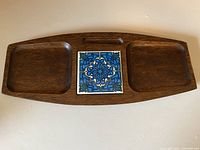 Full view of hardwood cheeseboard showing two wells and central tile