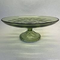 Side view of light green footed glass cake plate