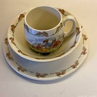Plate, bowl stacked under mug, showing Bunnykins patterns