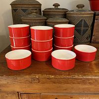 Stacked red ceramic ramekins showing full set