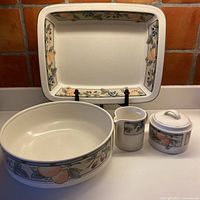 All four Mikasa Garden Harvest pieces displayed: platter, bowl, sugar bowl with lid, creamer