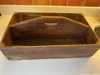 Top angled view showing full wooden divided box and handle