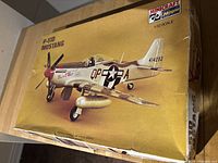 Box of Minicraft Hasegawa 1/32 scale P-51D Mustang model aircraft kit showing front artwork and product name