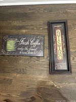 Both Bistro and Fresh Coffee signs positioned flat on wooden floor, showing design and size comparison