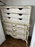 Front view of entire chest showing six drawers, curved front and brass handles