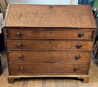 Front view closed showing four drawers and slanted top.