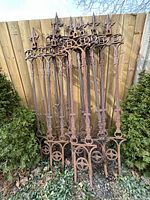 Eight panels leaning against wooden fence, full lot overview