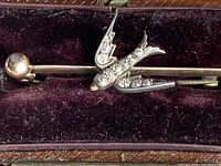 Close-up view of swallow motif showing diamonds set in wings and body