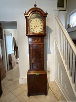 Full front view of tall case clock in room interior