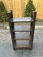 Front view showing four evenly spaced shelves