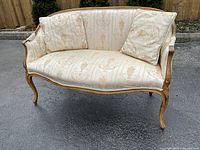 Front left three-quarter view of loveseat showing overall shape, frame and upholstery