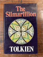 Front cover with dust jacket showing title and circular emblem design