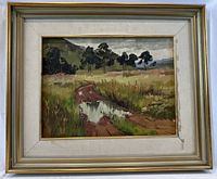 Frontal view of framed oil painting showing landscape scene
