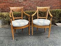 Front view of both armchairs together against brick backdrop