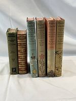 Front view of the six books showing the spines and dust jackets including the four Winston Churchill volumes and two additional vintage books.