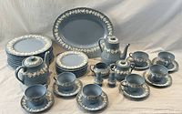 Full set arranged on cloth backdrop, showing cups, saucers, plates, pots, platter, creamer, sugar bowl, salt and pepper shakers.